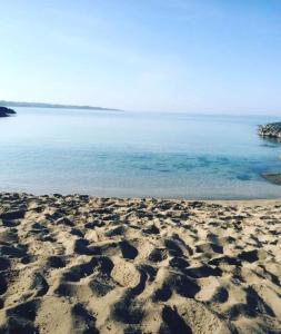 a sandy beach with the ocean in the background at Gallipoli Mancaversa Futura Vacanza Andrea in Marina di Mancaversa