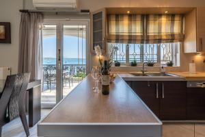 a kitchen with a table with a view of the ocean at Bay View House in Petalidi