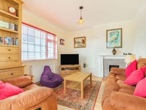 a living room with a couch and a tv at 38 Upton Towans in Hayle