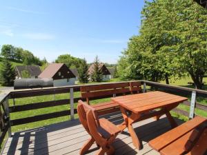 a wooden table and two chairs sitting on a deck at Holiday Home Holiday Hill 54 by Interhome in Cerny Dul