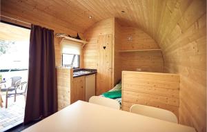 a room with a table and chairs in a tiny house at Amazing Home In Ssel With Wifi in Süsel