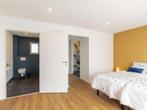 a bedroom with a bed and a bathroom at Holiday Home Les Bruyères by Interhome in Tréflez