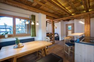 a kitchen and dining room with a wooden table at Haus Rendl 1 in Bramberg am Wildkogel