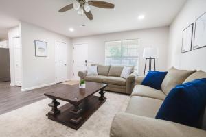 a living room with a couch and a table at Trailside Townhouse - Close to Downtown & Bike Trails in Bentonville