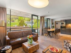 a living room with a couch and a table at Apartment Top 2 by Interhome in Zell am See