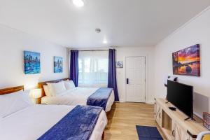 a hotel room with two beds and a flat screen tv at The Chalets at Kings Beach III in Kings Beach