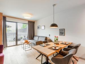 a living room with a table and a couch at Apartment Emma Deluxe Aparthotel-7 by Interhome in Fürth