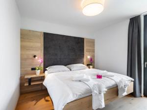 um quarto com uma cama grande e lençóis brancos em Apartment Emma Deluxe Aparthotel-9 by Interhome em Fürth