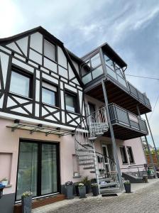 a house with a staircase on the side of it at Ferienwohnung-Mesenich in Zell an der Mosel