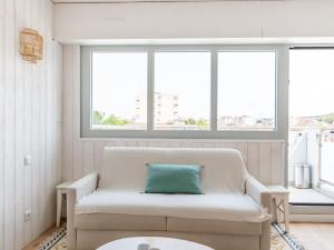 a living room with a couch and two windows at Studio Jetée des Marins-5 by Interhome in Arcachon
