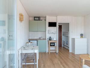 a small kitchen with a table and a counter top at Studio Jetée des Marins-5 by Interhome in Arcachon