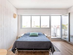 a bedroom with a bed and a large window at Studio Jetée des Marins-5 by Interhome in Arcachon