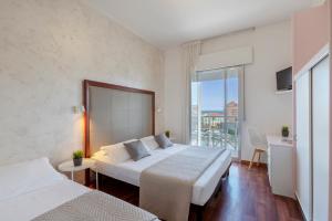 A bed or beds in a room at Hotel Imperiale