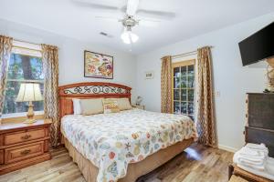 a bedroom with a bed and a ceiling fan at Geechee Girl in Edisto Beach