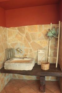 a stone bathroom with a sink on a table at Villa Rosalba in Polignano a Mare