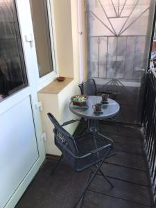 a small table and chairs on a balcony at Apartments on Shevchenko avenue in Lviv