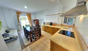a kitchen with a sink and a table in it at Apartamentos Costa Trafalgar in Zahora