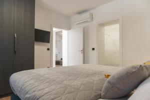 a bedroom with a large bed and a television at Apartman Sorelle in Kali