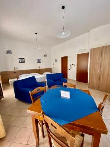 a living room with a dining table and a bed at Locanda Da Marco in Pignone