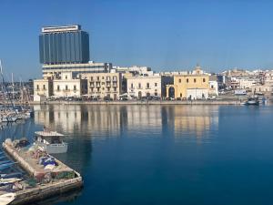 a harbor with a city and a boat in the water at room milo in Gallipoli