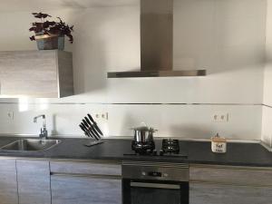 a kitchen with a sink and a stove top oven at Casa Collado in San Vicente