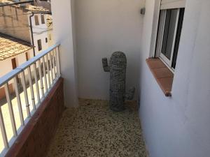 a cat statue sitting on the corner of a balcony at Casa Collado in San Vicente