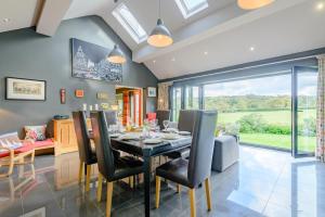 a dining room with a table and chairs at Benllech Beach House in Benllech