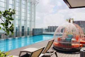 a bird cage sitting next to a swimming pool at Suasana Suites D'Home JB in Johor Bahru
