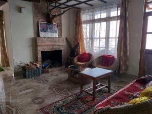 a living room with a couch and a fireplace at Sherpa Villa in Gangtok