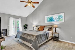 a bedroom with a bed and a ceiling fan at Morning Mist Lake House in Lithonia