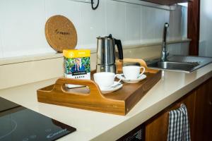 a wooden tray with cups on a kitchen counter at Casa Rural Encarna in Vega de San Mateo