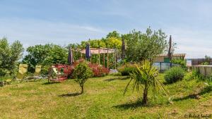 a yard with a garden with chairs and plants at Gites Les Granges De Flolie in Beauteville