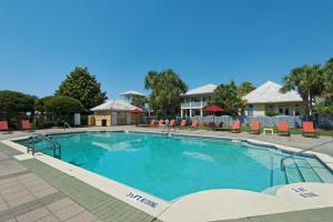 a large swimming pool with chairs and a house at Miramar Magic in Destin