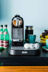 a coffee maker sitting on top of a table at Willa Port Apartament Premium z widokiem na jezioro in Ostróda