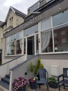 a building with a chair in front of it at Brooklyn Hotel in Blackpool