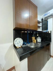 a kitchen with a sink and a counter top at Sto. Niño Residences Standard Room in Lucena