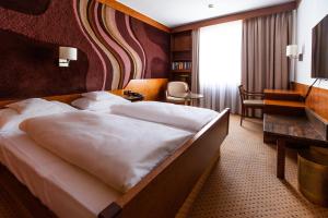 מיטה או מיטות בחדר ב-Hotel Royal