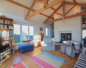 a living room filled with furniture and a fireplace at Ossco in Polzeath
