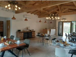 a kitchen with tables and chairs in a room at Kyrn Flor - Domaine Sant Antone in Corte