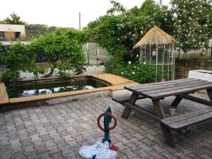 a picnic table with a gazebo and a pond at Maison de 4 chambres avec piscine privee et jardin clos a Aubenas a 1 km de la plage in Aubenas