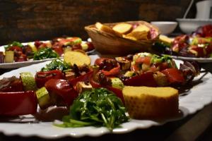 a plate of food with vegetables on a table at Hotel Kompas in Foča