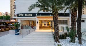 a hotel mirror with palm trees in front of it at Medplaya Hotel Riudor - Adults Recommended in Benidorm
