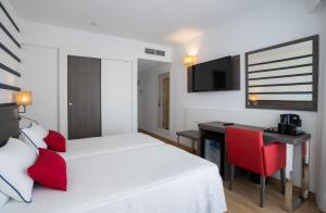 a hotel room with a bed and a desk and a television at Medplaya Hotel Riudor - Adults Recommended in Benidorm