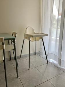 a table and a chair next to a window at Uranias Beach House in Kalives Poligirou