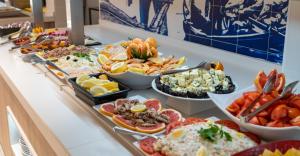 a buffet with many different types of food on a counter at Medplaya Hotel Riudor - Adults Recommended in Benidorm