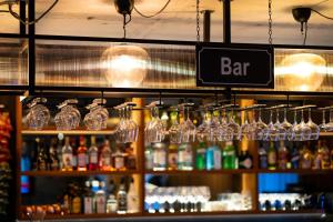 a bar with glasses and bottles of alcohol at Konvin Hotel by Reykjavik Keflavik Airport in Keflavík
