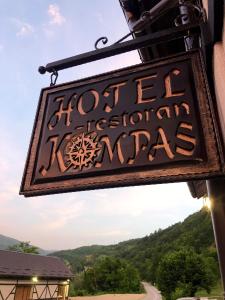 a sign for a hotel in the mountains at Hotel Kompas in Foča