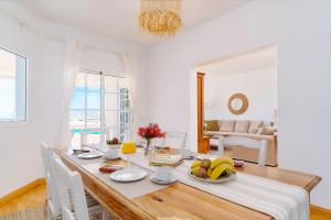a dining room with a table with fruit on it at Villa Fika, Amazing 3 bedroom Ocean View with Pool in Tías