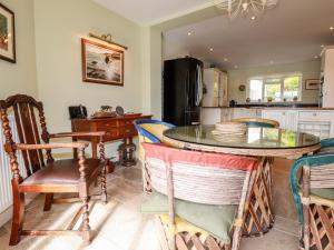 a kitchen with a table and some chairs and a counter at Condurro House in Truro