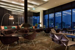 a hotel lobby with a view of the city at Crown Metropol Melbourne in Melbourne